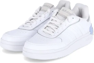 A pair of white Adidas sneakers is shown against a white background.