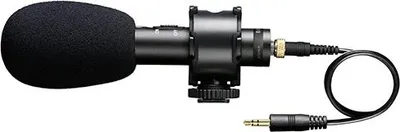 A studio microphone with a wind screen and cable is shown against a white background.