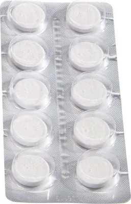 A blister pack of white cleaning tablets for coffee machines.