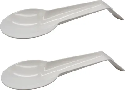 Two white plastic spoon rests are shown against a white background.