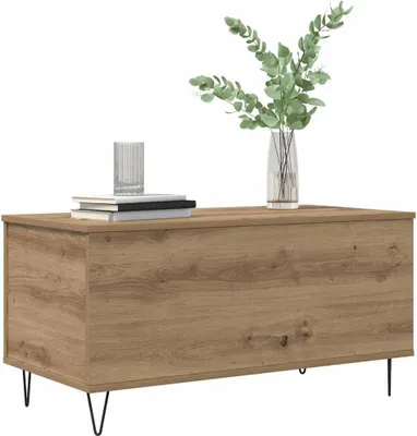 A wooden coffee table with books and a vase of greenery on top, set against a white background.