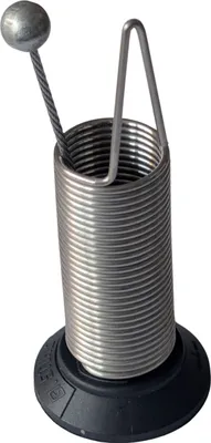A close-up studio shot of a metal spring mechanism with a ball on a wire attached.