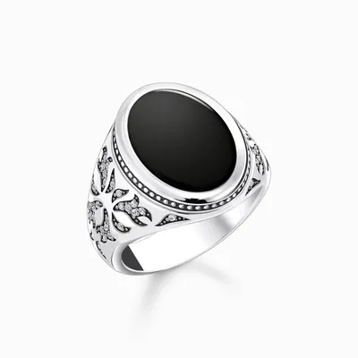 A silver ring with a black oval stone and intricate detailing.