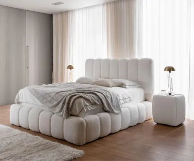 A bedroom with a large, plush bed.