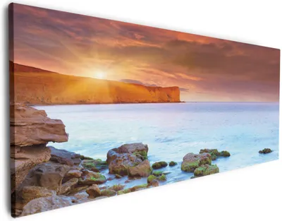 Produktbild von Wallario Premium Leinwandbild Sonnenaufgang am Meer mit Landzunge und Felsen im Wasser in Größe 80 x 200 cm