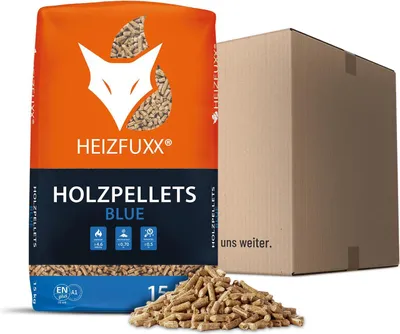 A bag of Heizfuxx Holzpellets Blue with a cardboard box in the background and some pellets scattered in the foreground.