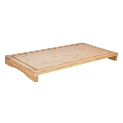 A wooden cutting board is shown from a side-angle perspective against a white background.