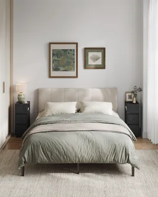 A bedroom scene with a bed, nightstands, and artwork.