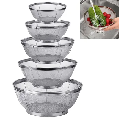 A set of five stainless steel colanders of varying sizes are stacked on top of each other against a white background. A small inset image in the upper right corner shows a hand washing cucumbers and radishes in one of the colanders in a sink.