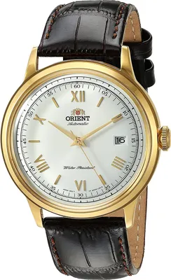 A close-up studio shot of a gold-toned Orient Bambino automatic watch with a white dial and a black leather strap.