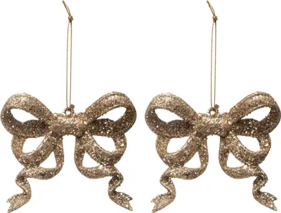Two glittery gold bow ornaments hanging against a white background.