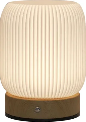 A close-up, front-facing view of a white, ribbed table lamp with a wooden base.