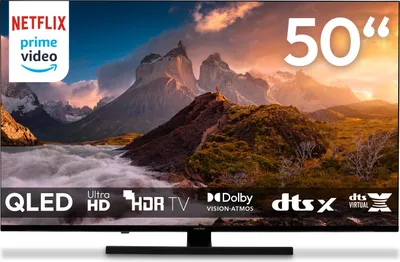 A television screen displaying a mountain landscape, with various logos and text overlays indicating features.