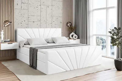 A white upholstered bed with a headboard and footboard is shown in a bedroom setting.