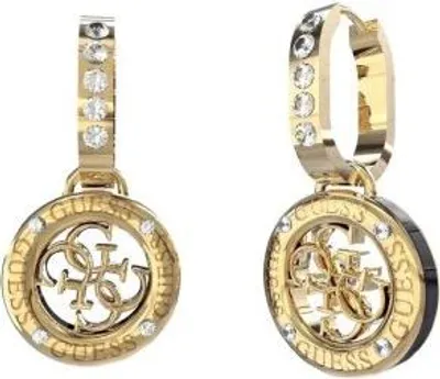 A pair of gold-toned hoop earrings with circular pendants, each featuring the Guess logo and small clear stones.