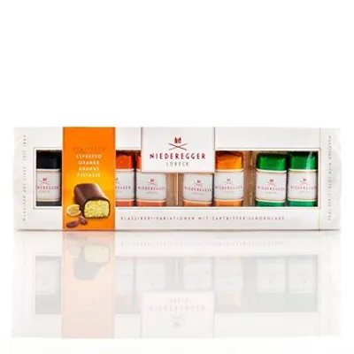 A product shot of a box of Niederegger marzipan variations, with individual marzipan pieces visible.