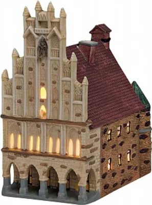 A miniature, illuminated building resembling a town hall.