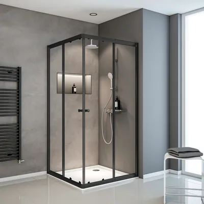 A modern bathroom with a black framed glass shower enclosure.