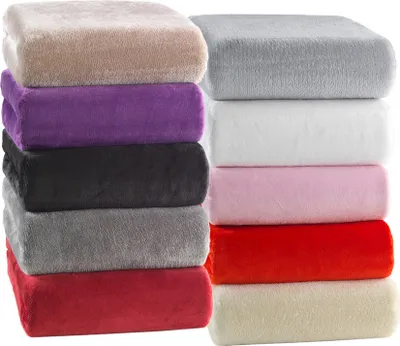 A stack of folded blankets in various colors.