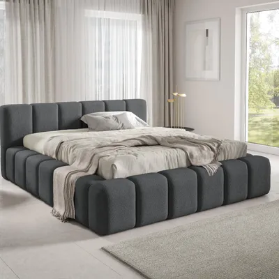 A modern bedroom with a large upholstered bed.