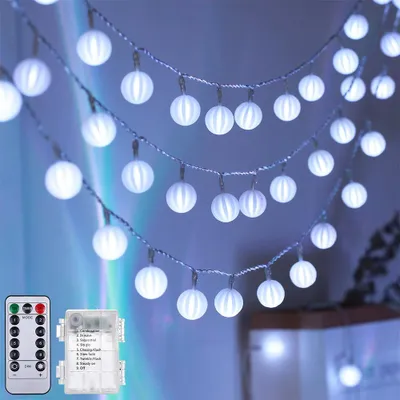 A string of white LED lights with spherical bulbs, hung indoors.