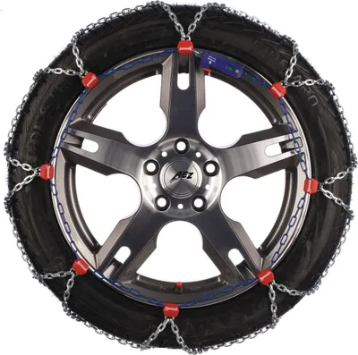 A snow chain is fitted to a car wheel.