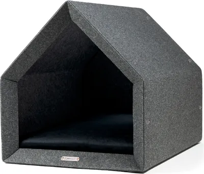 A dark gray, house-shaped pet bed with a dark blue cushion inside, shown from a three-quarter angle against a white background.