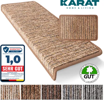 A close-up of a light brown, rectangular stair mat with a textured surface and a darker brown edge, shown diagonally on a white background. A smaller inset image of the same mat is also visible. Several other color variations of the mat are displayed in a 