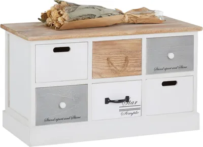 A storage bench with six drawers and a bouquet of dried flowers on top.