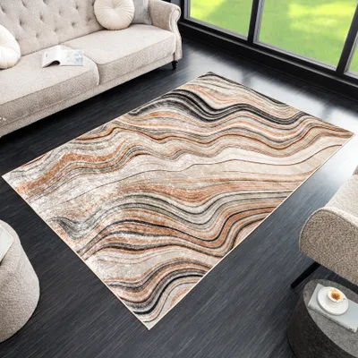 A modern living room with a rug, sofa, and armchair.
