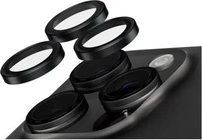 A close-up view of a smartphone camera module with several lens protectors arranged above it.