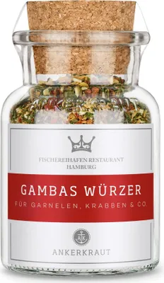 A glass jar of spice blend with a cork stopper, placed on a white background.