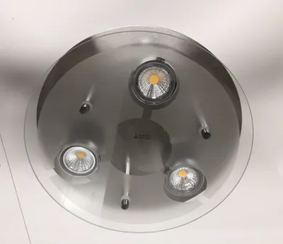 A ceiling light fixture with three LED spotlights.
