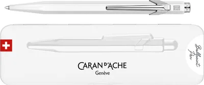A white CARAN D'ACHE ballpoint pen and its packaging.