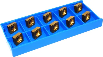 A set of 10 gold-colored metal inserts with a hole in the center, arranged in a blue plastic tray. The inserts appear to be cutting tool inserts.