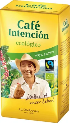 A yellow coffee packaging box with a man's face and coffee beans on it.