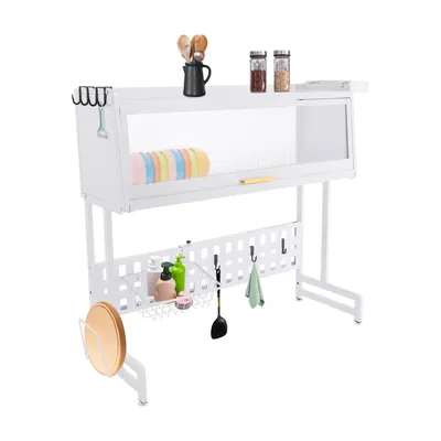 A white dish drying rack with various kitchen items on it, including plates, bottles, utensils, and a cutting board.