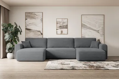 A modern living room with a large sectional sofa, artwork, and a houseplant.