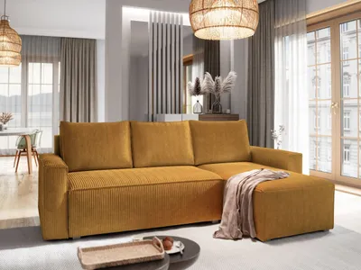 A modern living room with a yellow sectional sofa, ottoman, and decorative elements.