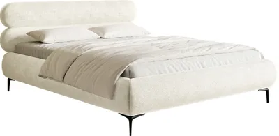 A cream-colored upholstered bed with black legs, shown from a side-front angle against a white background.