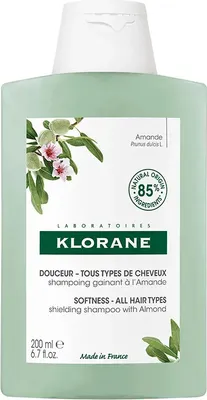 A bottle of Klorane shampoo with almond milk.