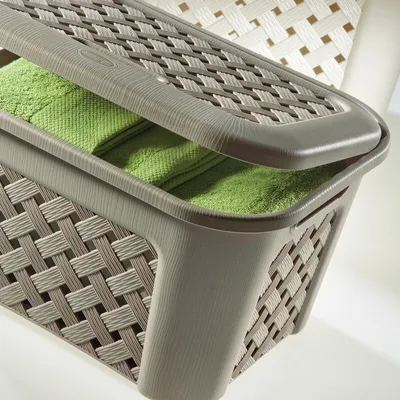 A close-up shot of a laundry basket with green towels inside.