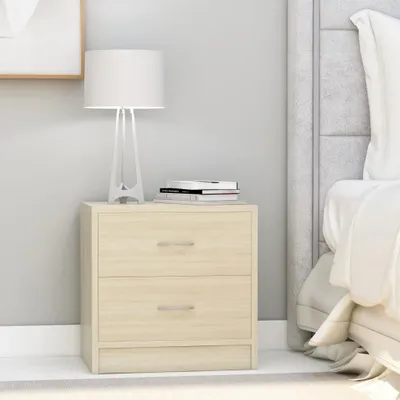 A bedside table with two drawers next to a bed.