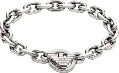 A close-up studio shot of a silver chain bracelet with an eagle logo clasp.