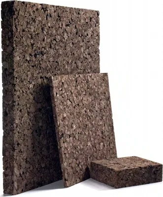 Three rectangular blocks of cork are arranged in a staggered formation against a white background.