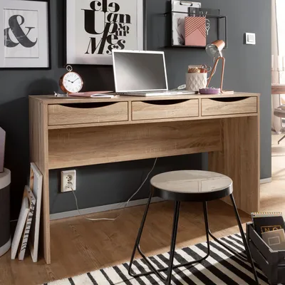 A home office setup with a desk, laptop, and stool.