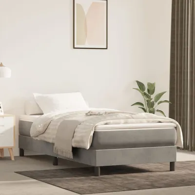 A bedroom scene with a single bed, nightstand, and artwork on the wall.