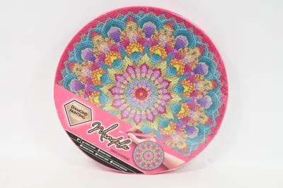 A circular diamond painting kit with a mandala design on a pink backing, presented against a white background.