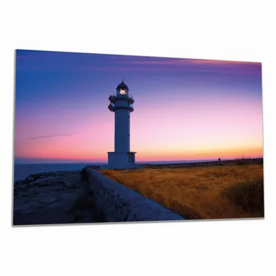 Produktbild von Wallario Herdabdeckplatte aus Glas, Größe 80 x 52 cm 1-teilig, Motiv Leuchtturm am Abend auf den Balearen Malerischer Himmel