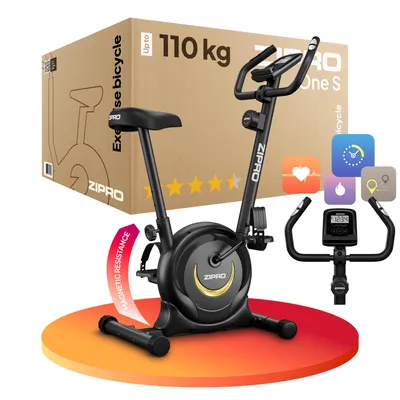 A black exercise bike is shown on a colorful circular platform, with a cardboard box in the background.
